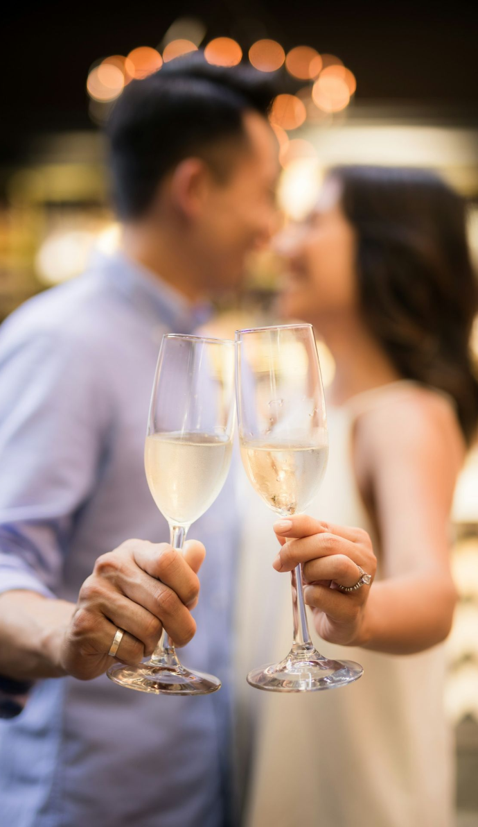 selective focus photography of couple holding cocktail glasses